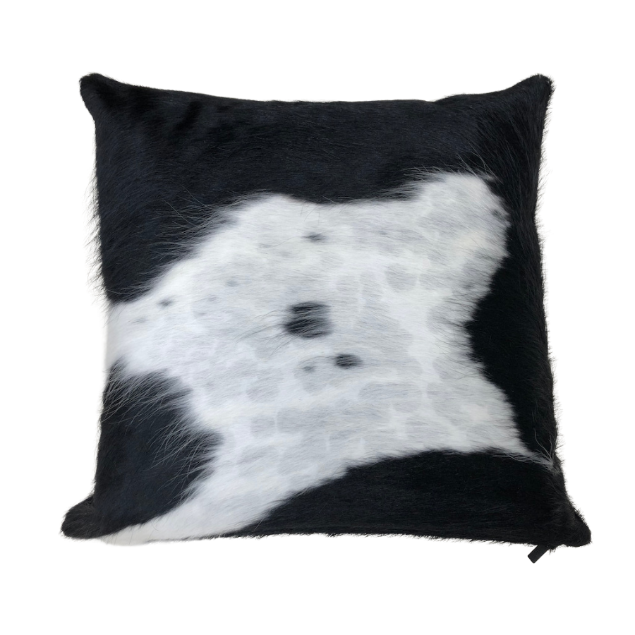 Black and white cowhide cushion showing natural hair texture and distinctive hide pattern