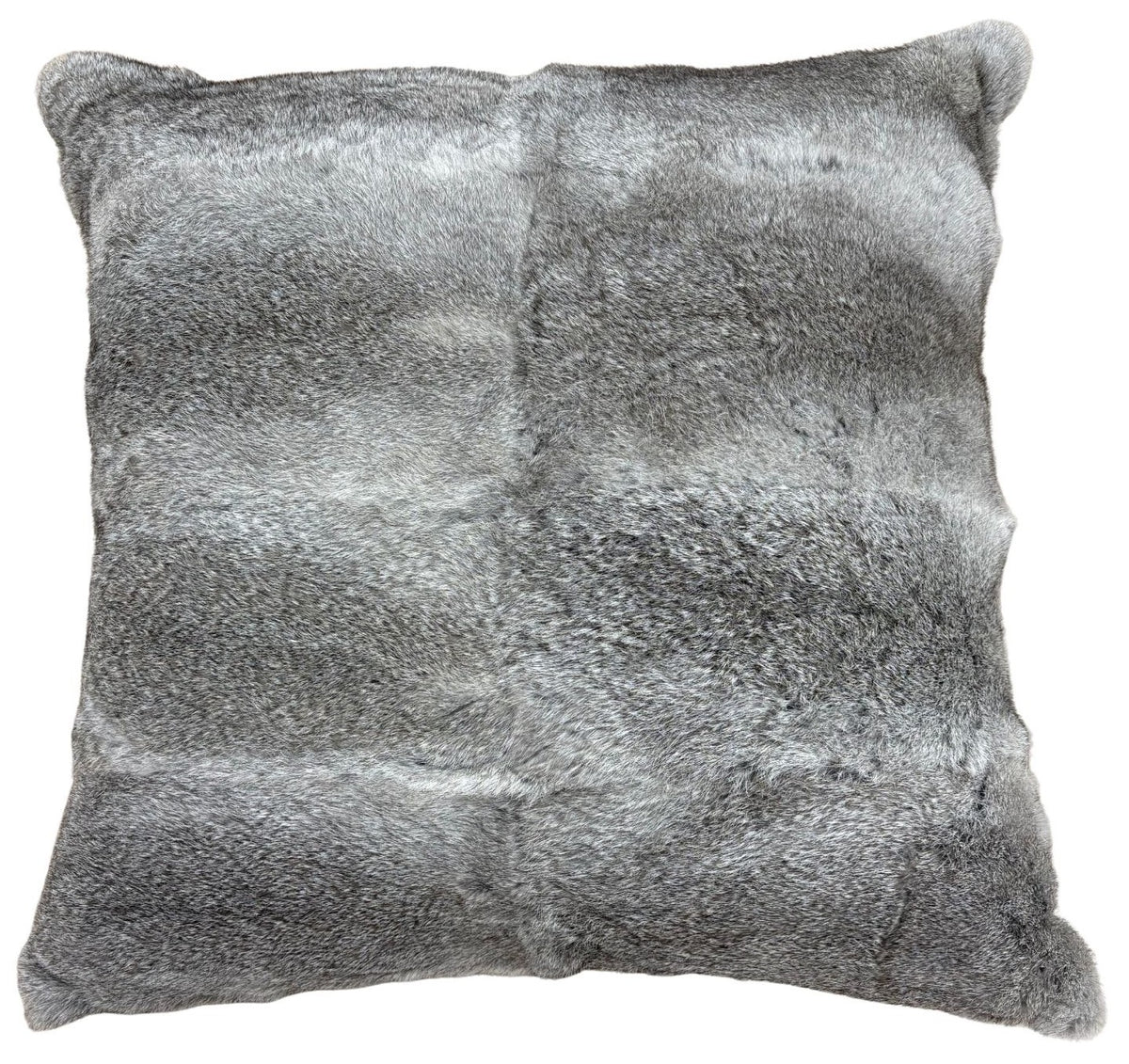 A grey rabbit fur pillow in a 60cm size styled on a chair, showing its soft texture and natural fur detail.