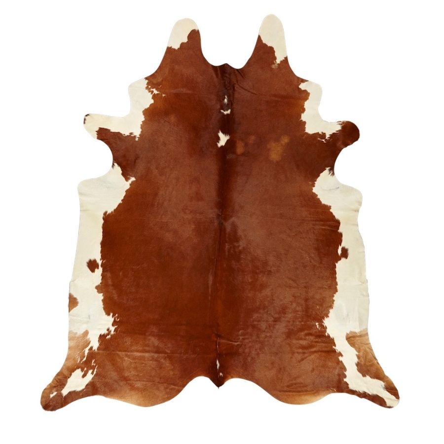 Large brown and white Hereford cowhide rug with natural symmetrical markings on a white background