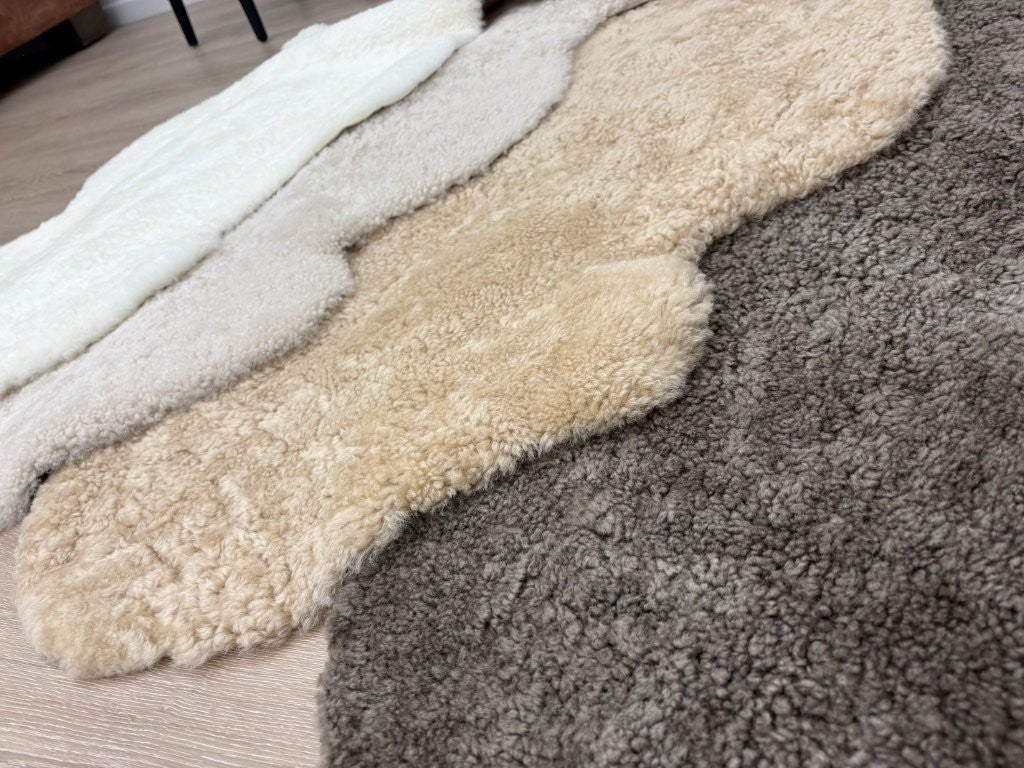 Genuine shearling rug collection showcasing Natural White, Oatmeal, Honey and Chocolate Fleck colour options.