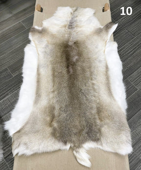 Beige reindeer hide throw numbered 10 showing natural markings and shape