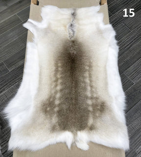 Beige reindeer hide throw numbered 15 showing natural markings and shape