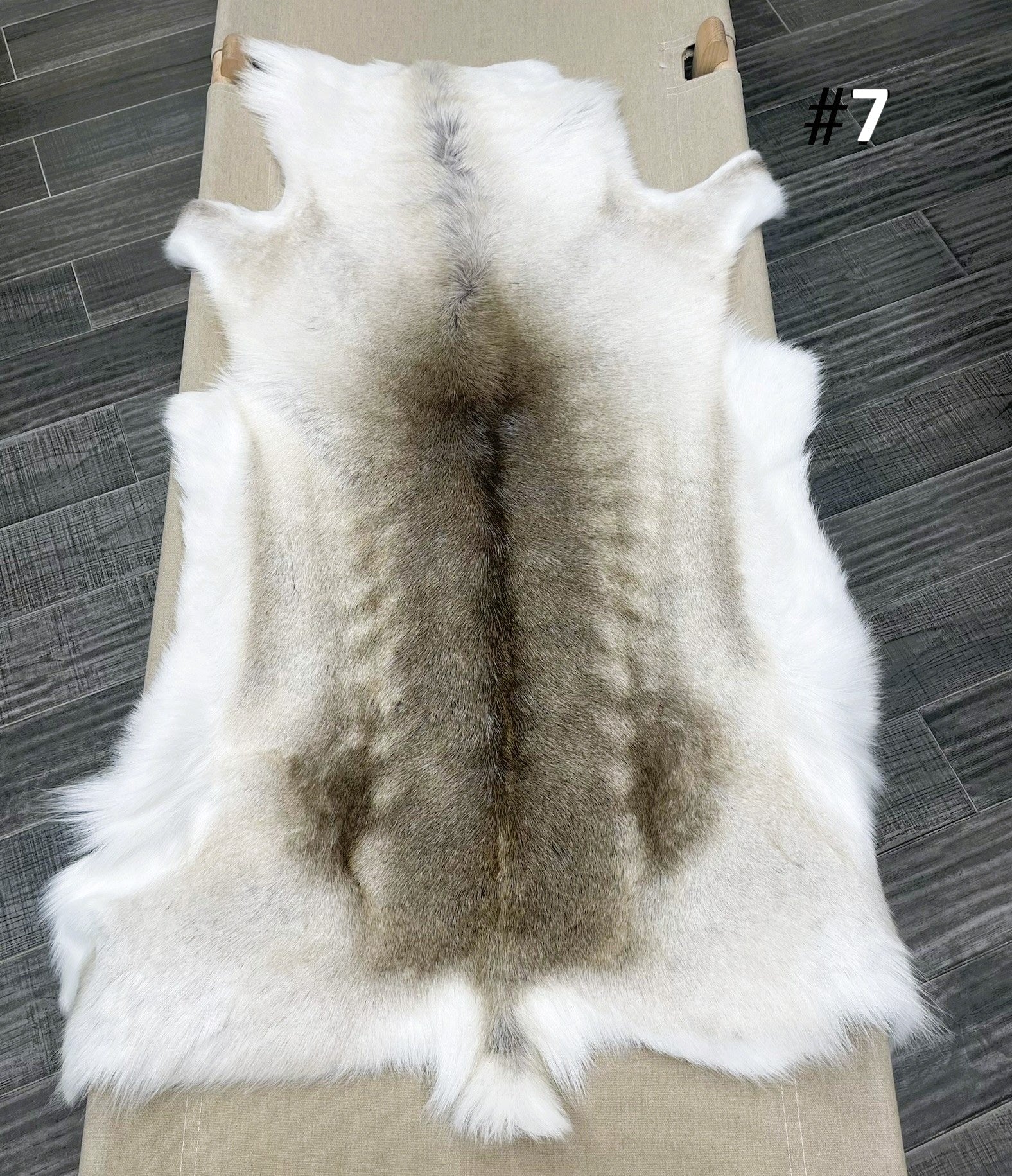 Beige reindeer hide throw numbered 7 showing natural markings and shape