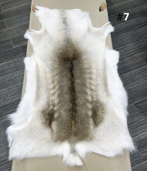 Beige reindeer hide throw numbered 7 showing natural markings and shape