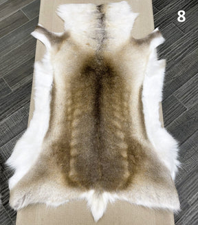 Beige reindeer hide throw numbered 8 showing natural markings and shape