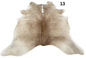 Beige and white cowhide rug No. 13 featuring soft neutral tones and natural hide character.