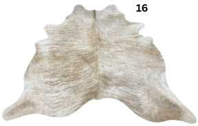 Beige and white cowhide rug No. 16 featuring soft neutral tones and natural hide character.