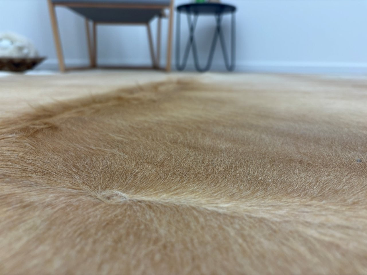 Detail of beige and white cowhide rug showing natural hair finish