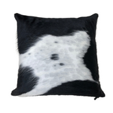 Black and white cowhide cushion showing natural hair texture and distinctive hide pattern