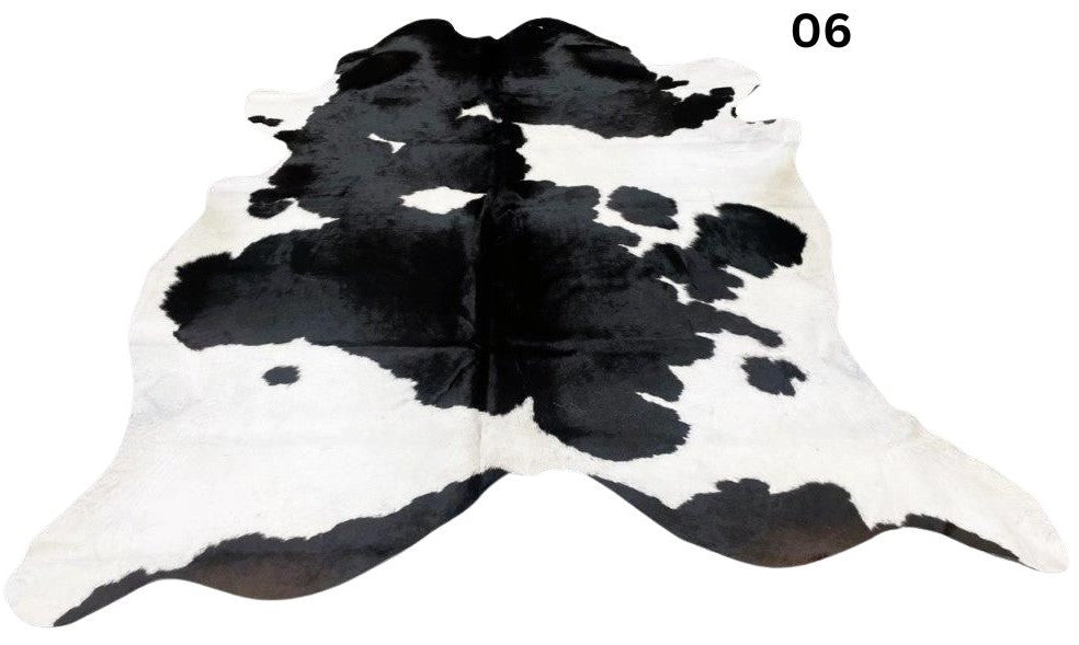 Black and white cowhide rug number 06 with bold contrast markings on a white background