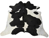 Black and white cowhide rug example showing bold contrast markings on a white background