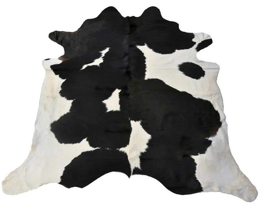 Black and white cowhide rug example showing bold contrast markings on a white background