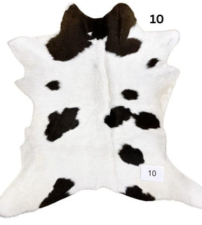 Natural brown and white calf hide rug shown individually on a white background