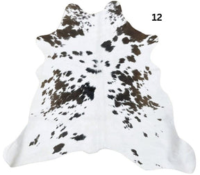 Natural brown and white calf hide rug shown individually on a white background