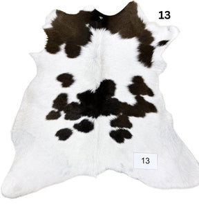 Natural brown and white calf hide rug shown individually on a white background