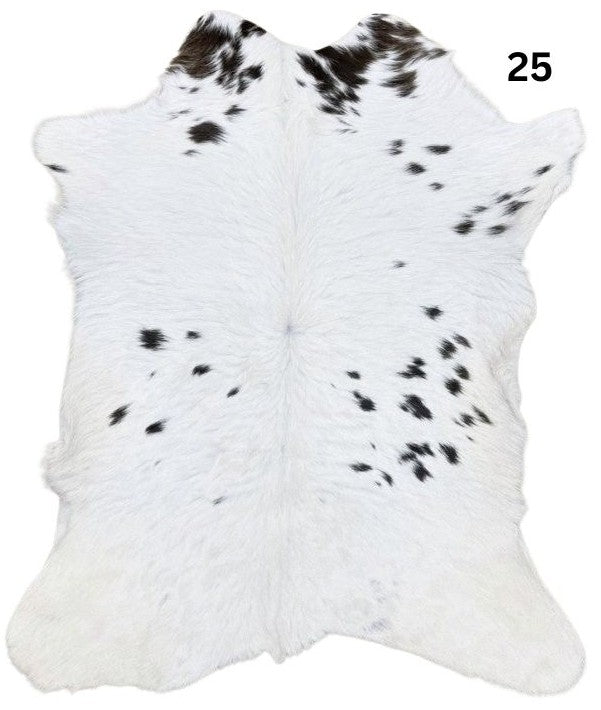 Natural brown and white calf hide rug shown individually on a white background