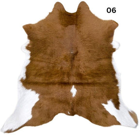 Natural brown and white calf hide rug shown individually on a white background