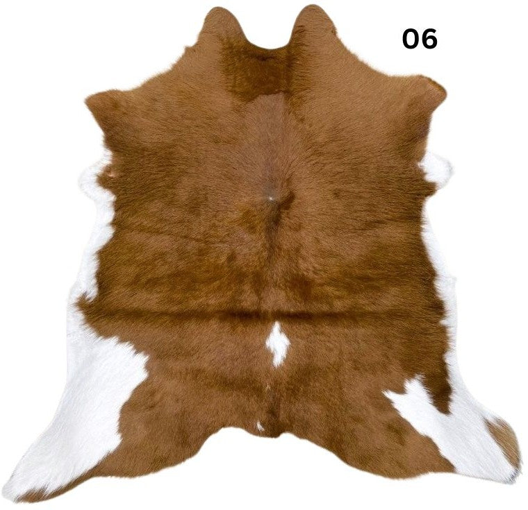Natural brown and white calf hide rug shown individually on a white background