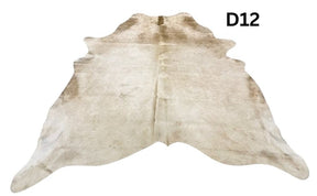 Champagne cowhide rug number 12 with soft neutral tones and natural markings on a white background