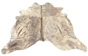 Champagne cowhide rug example showing soft neutral tones with natural variation and smooth hair on a white background