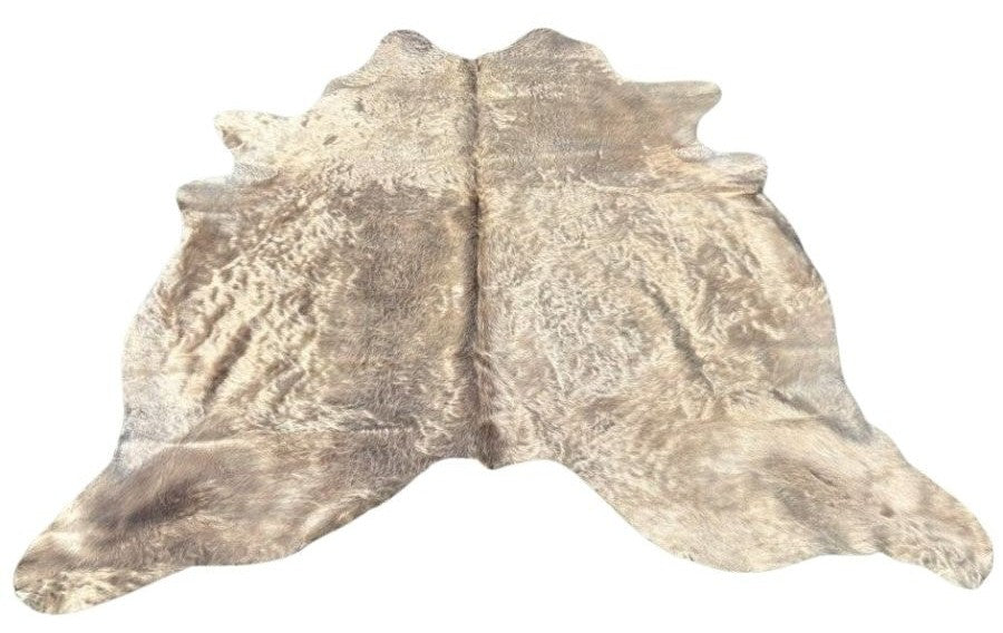 Champagne cowhide rug example showing soft neutral tones with natural variation and smooth hair on a white background