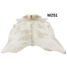Beige and white cowhide rug with natural tonal variation shown on a white background