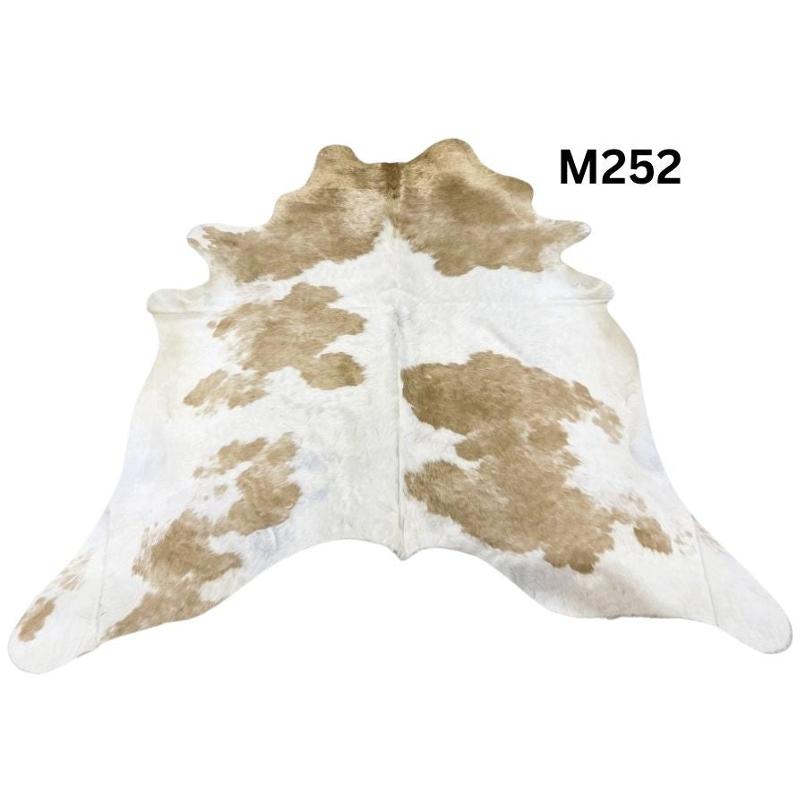 Beige and white cowhide rug with natural tonal variation shown on a white background