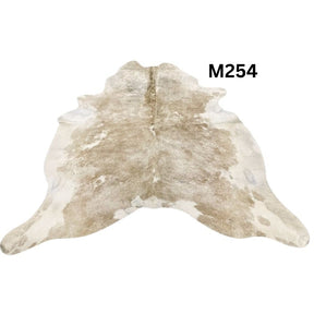 Beige and white cowhide rug with natural tonal variation shown on a white background