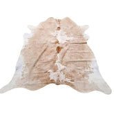 Example of a beige and white cowhide rug with natural variation shown on a white background