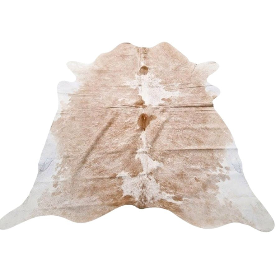 Example of a beige and white cowhide rug with natural variation shown on a white background