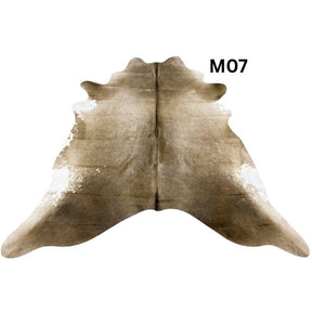 Mocha latte cowhide rug with natural markings shown on a light background