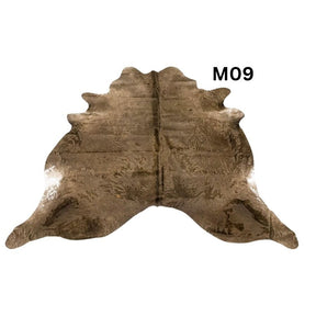 Mocha latte cowhide rug with natural markings shown on a light background
