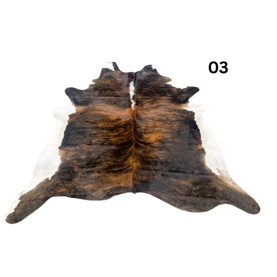 White belly cowhide rug with white spine and natural tonal variation shown on a white background