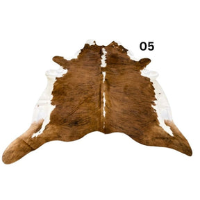 White belly cowhide rug with white spine and natural tonal variation shown on a white background