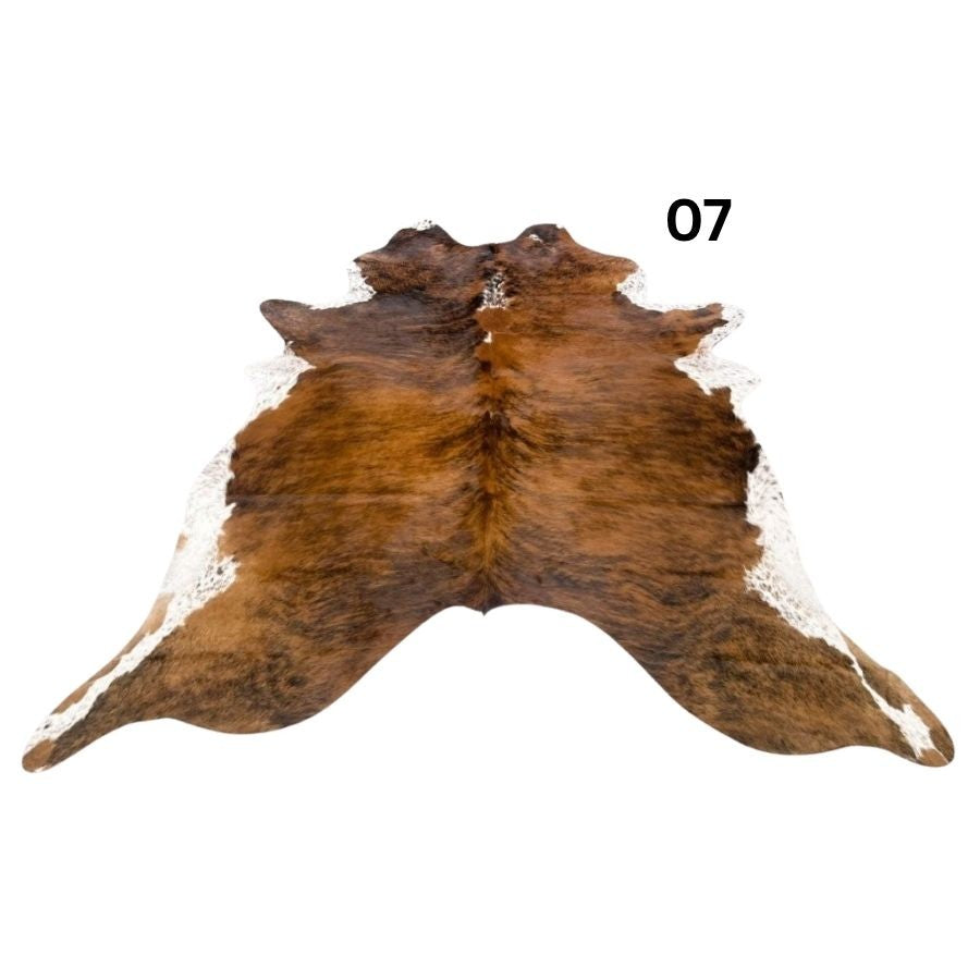 White belly cowhide rug with white spine and natural tonal variation shown on a white background