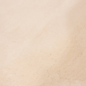 Close-up of dusk sheepskin baby rug showing fine wool fibres and warm tonal variation