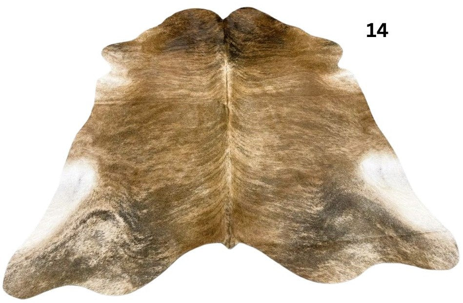 Exotic brindle cowhide rug number 14 featuring light and dark natural variation with speckled markings on a white background