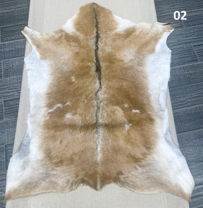 Natural goatskin hide rug shown individually