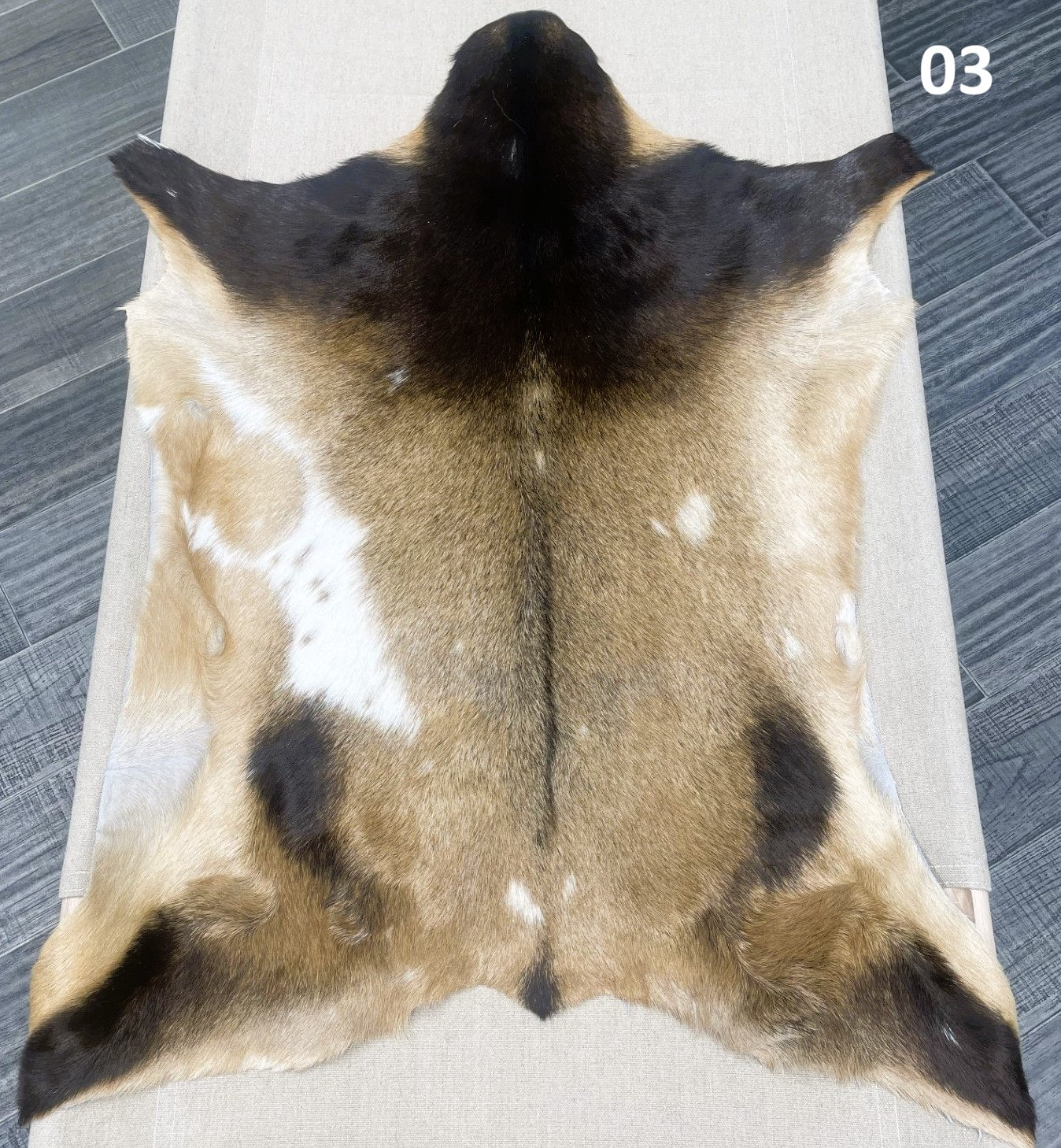 Natural goatskin hide rug shown individually