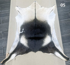 Natural goatskin hide rug shown individually