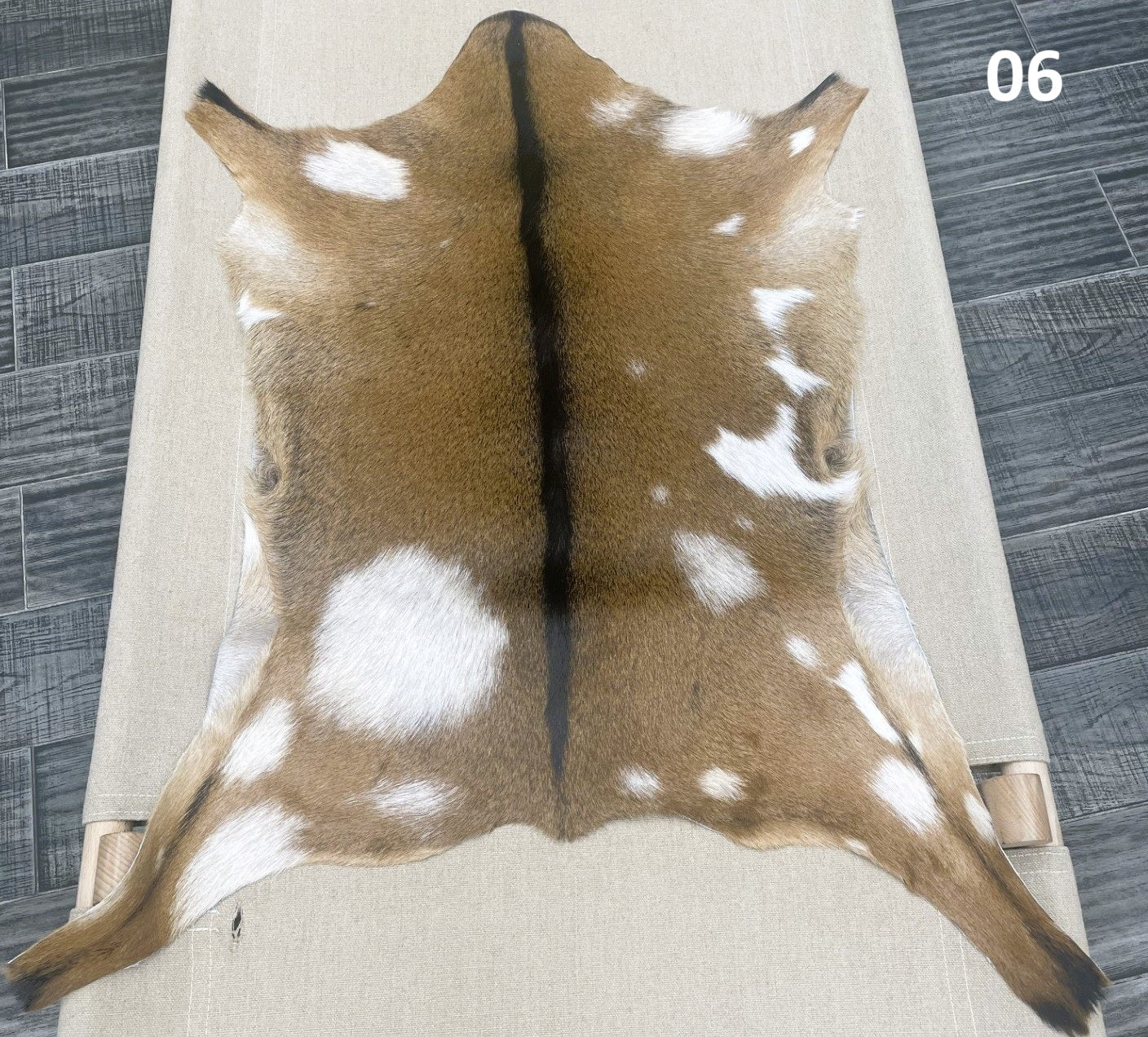 Natural goatskin hide rug shown individually
