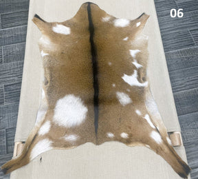 Natural goatskin hide rug shown individually