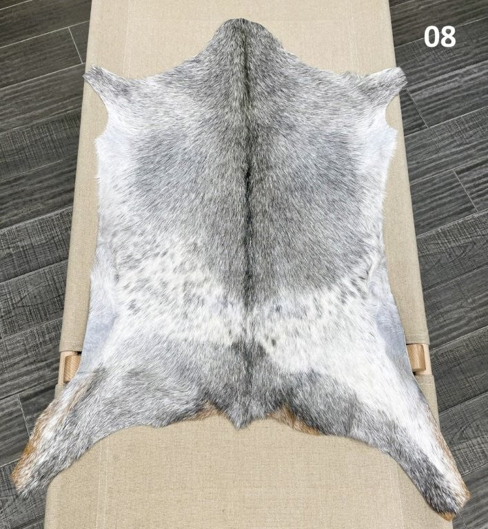 Natural goatskin hide rug shown individually