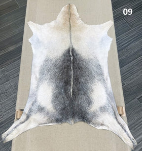 Natural goatskin hide rug shown individually
