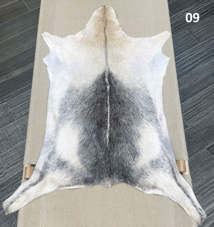 Natural goatskin hide rug shown individually