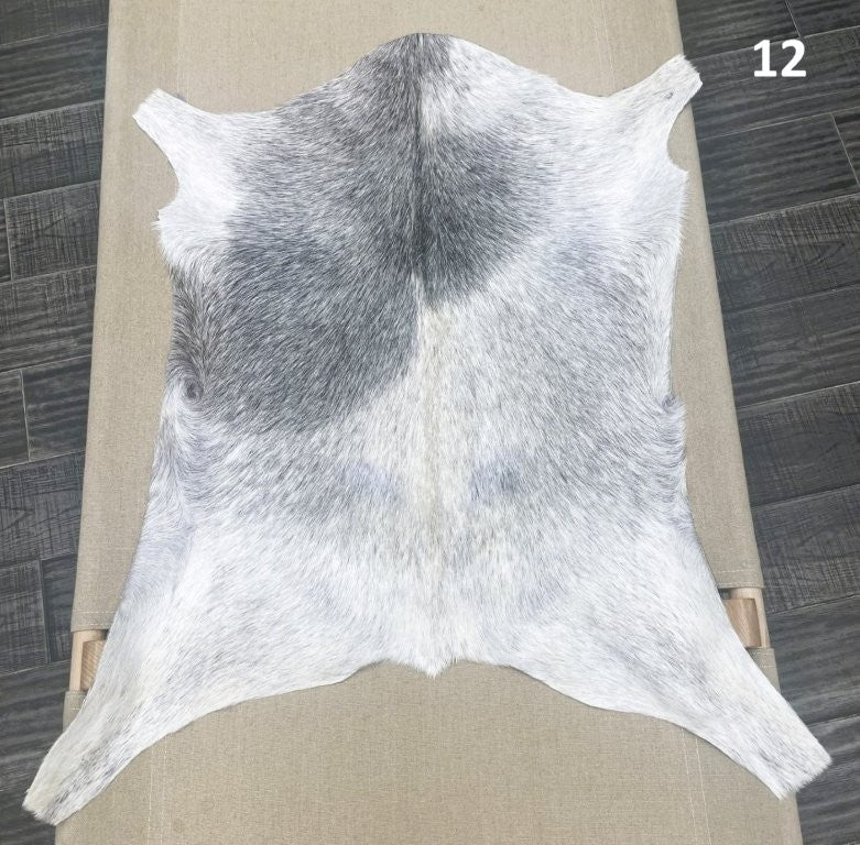 Natural goatskin hide rug shown individually