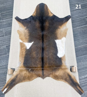 Natural goatskin hide rug shown individually