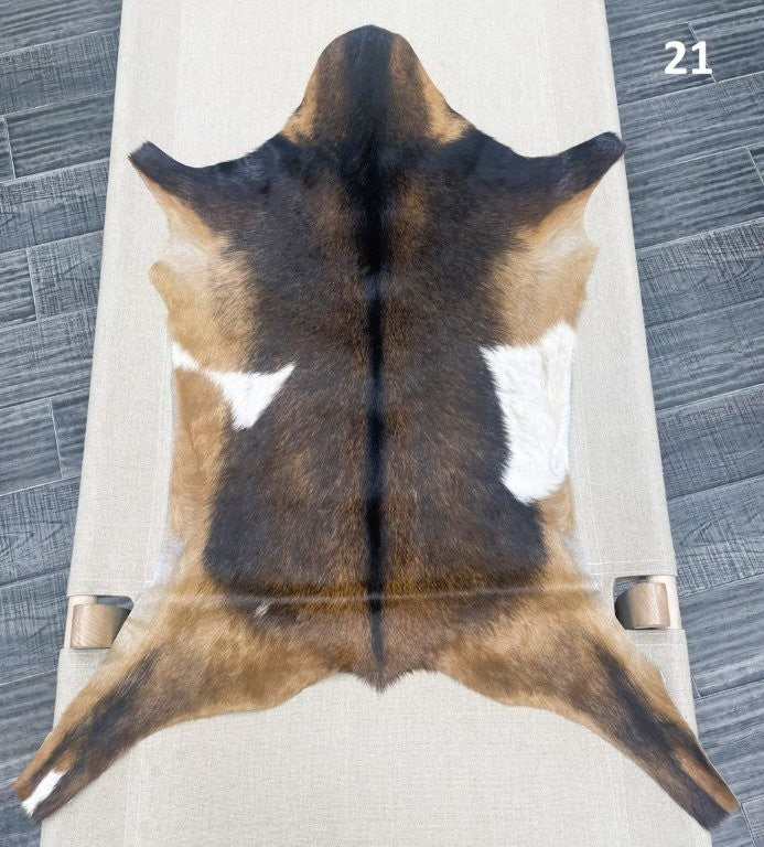 Natural goatskin hide rug shown individually
