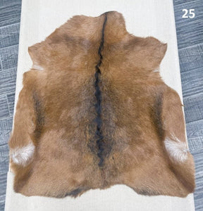 Natural goatskin hide rug shown individually