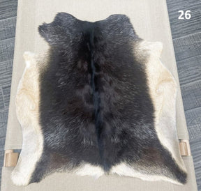 Natural goatskin hide rug shown individually